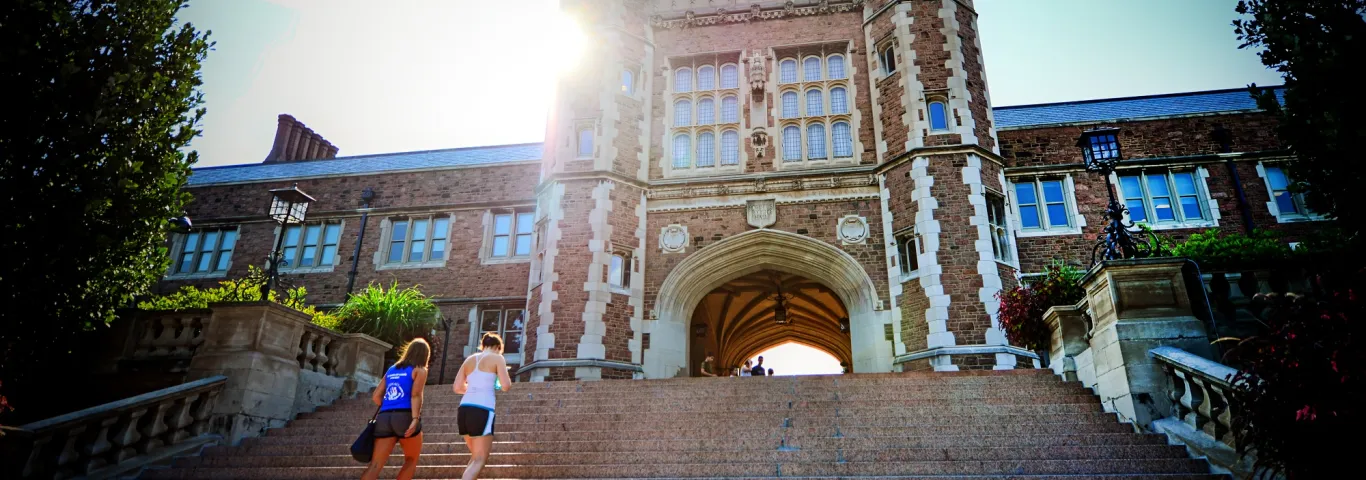 two students walking up the steps of brookings hall