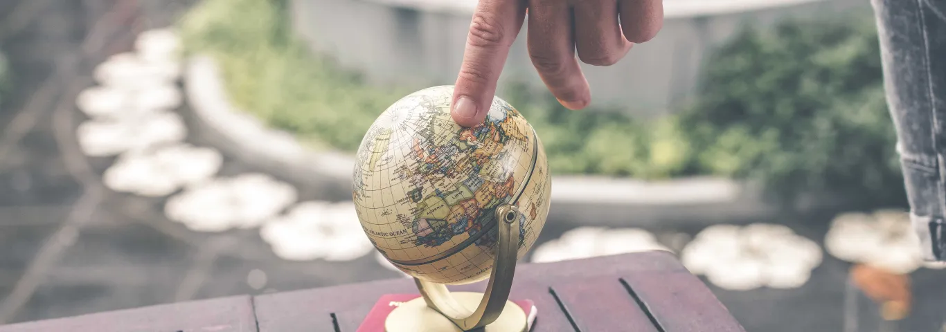 finger on globe 