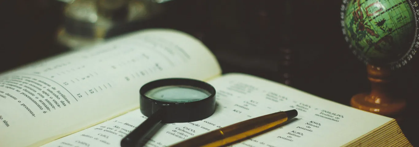 Open book with magnifying glass