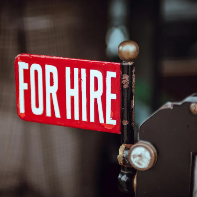 red sign with the words for hire written 